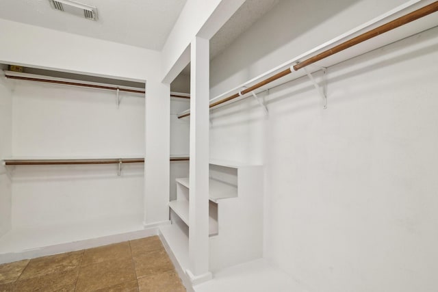 spacious closet featuring visible vents