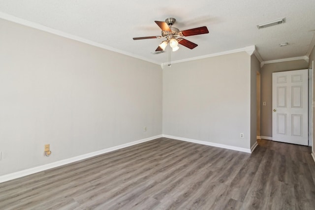 unfurnished room with visible vents, crown molding, baseboards, and wood finished floors