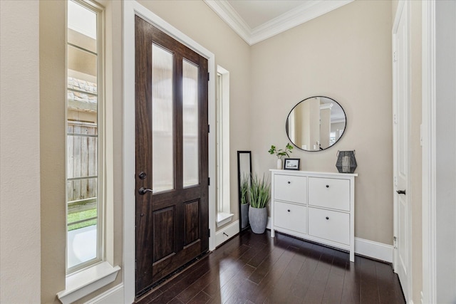 entrance foyer with dark wood-type flooring, crown molding, and baseboards