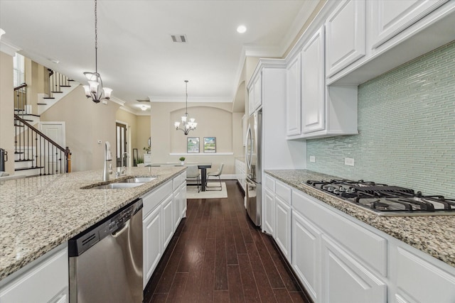 kitchen featuring a notable chandelier, dark wood-style flooring, a sink, white cabinets, and appliances with stainless steel finishes