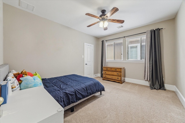 bedroom with baseboards, visible vents, and light colored carpet