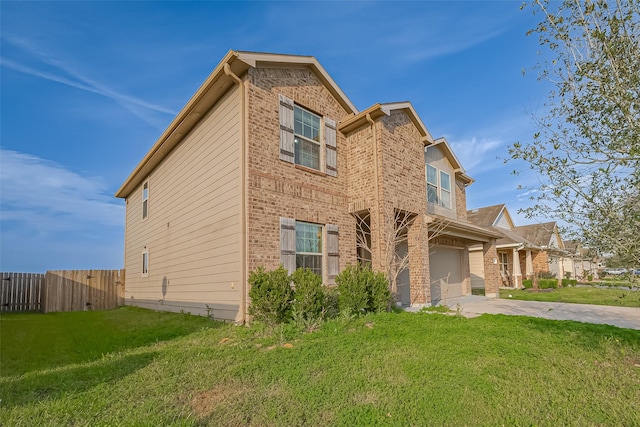 view of side of property with a yard, concrete driveway, brick siding, and fence