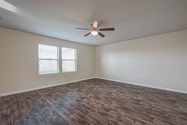 empty room featuring ceiling fan, baseboards, and dark wood-type flooring