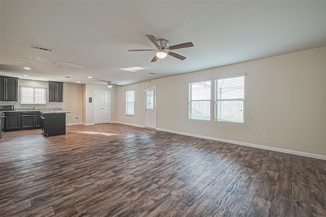 unfurnished living room with ceiling fan, recessed lighting, visible vents, baseboards, and dark wood finished floors