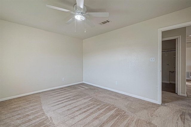 unfurnished room featuring a ceiling fan, baseboards, visible vents, and carpet flooring