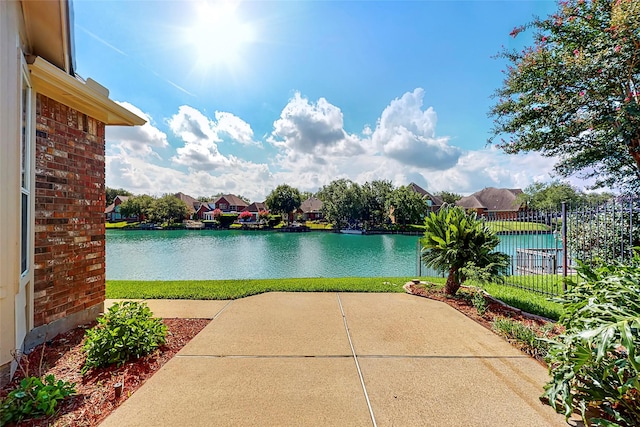 property view of water featuring a residential view and fence