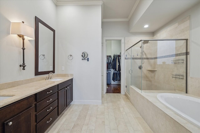 full bath featuring double vanity, a bath, ornamental molding, a shower stall, and a sink