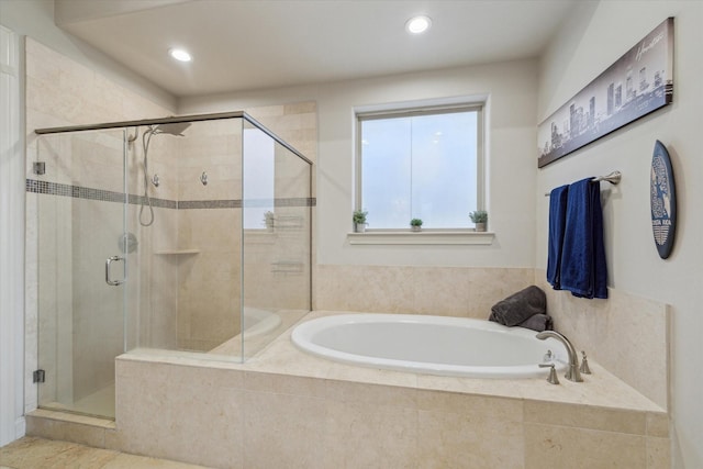 full bathroom with a shower stall, a bath, and recessed lighting