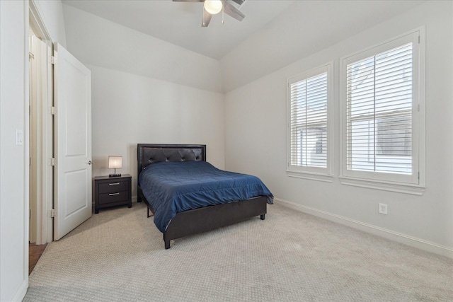 bedroom with light carpet, ceiling fan, lofted ceiling, and baseboards