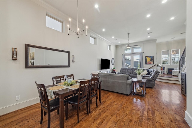 dining room with baseboards, stairway, wood finished floors, and crown molding