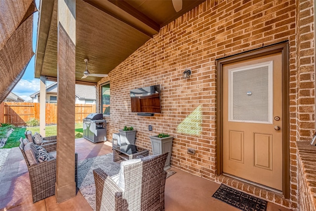 view of patio / terrace with a grill, an outdoor living space, and fence