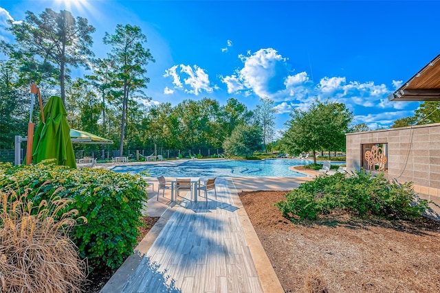 pool with a patio area and fence