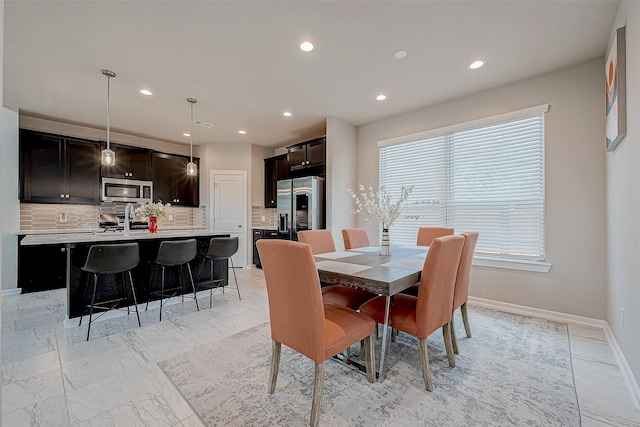 dining space with recessed lighting, marble finish floor, and baseboards