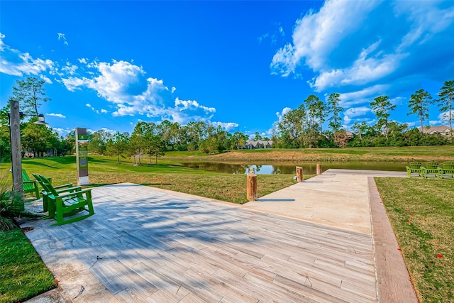 view of community with a water view and a yard