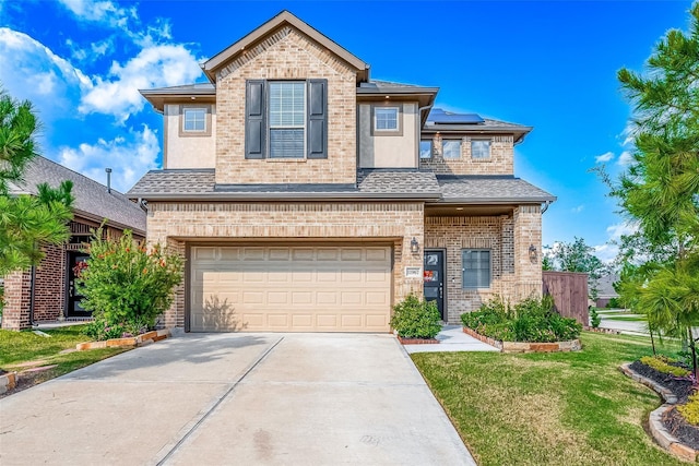 view of front of house featuring an attached garage, solar panels, a shingled roof, driveway, and a front yard