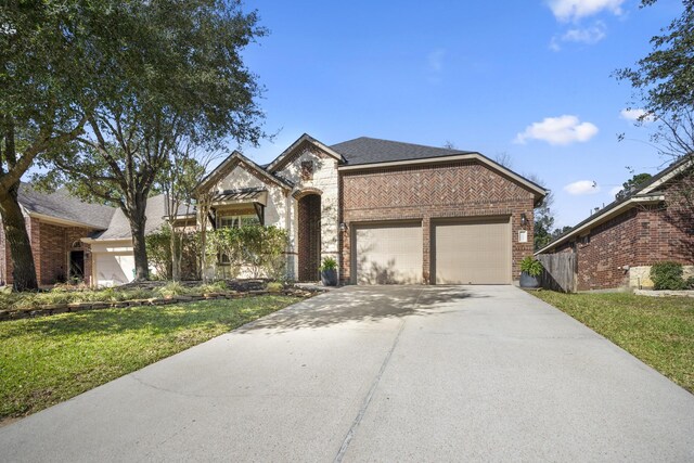 view of front of house featuring a garage, concrete driveway, brick siding, and a front lawn