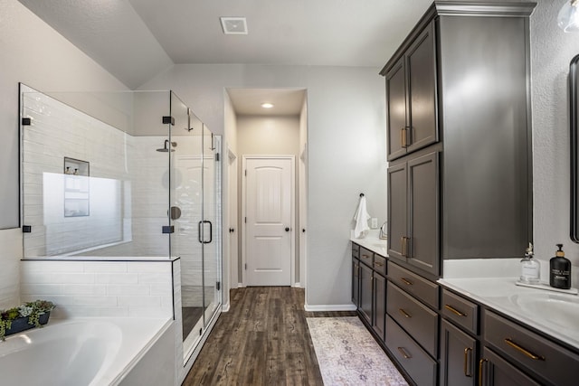 full bath with double vanity, visible vents, a stall shower, wood finished floors, and a bath