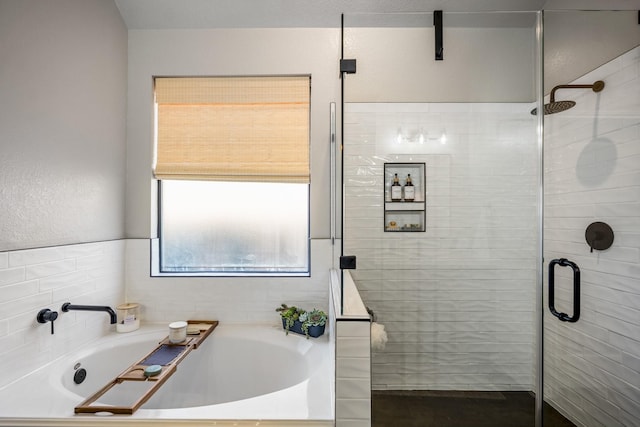 full bathroom featuring a stall shower and a garden tub