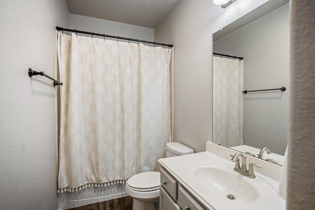 bathroom with vanity, toilet, and wood finished floors