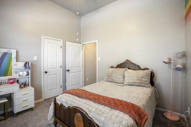 bedroom featuring a high ceiling, carpet flooring, and baseboards