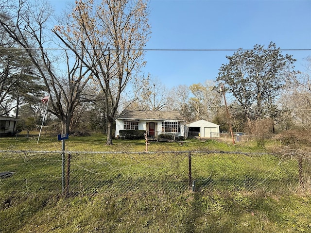 view of front of property featuring a garage, a front yard, and fence