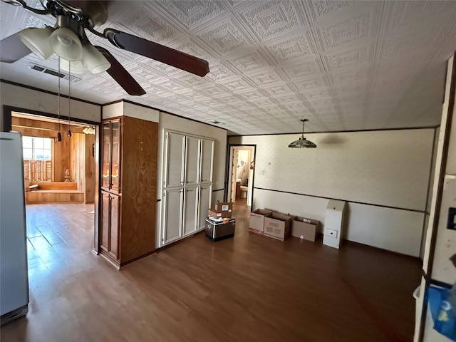 spare room with an ornate ceiling, visible vents, crown molding, and wood finished floors