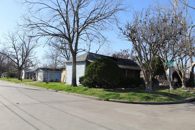 view of property exterior with a yard