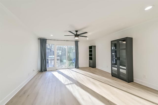 empty room with a ceiling fan, baseboards, wood finished floors, and recessed lighting