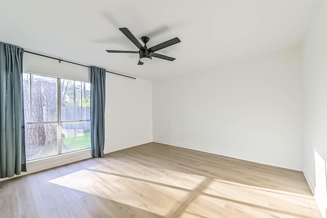 empty room featuring a ceiling fan and wood finished floors