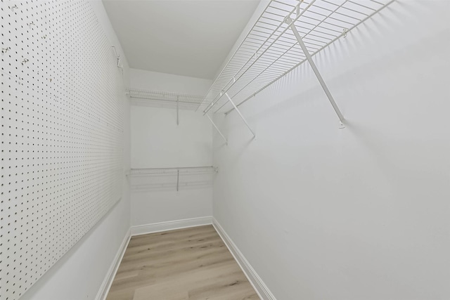 spacious closet with light wood finished floors