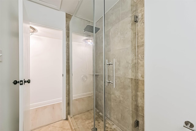 bathroom featuring tile patterned flooring and a shower stall