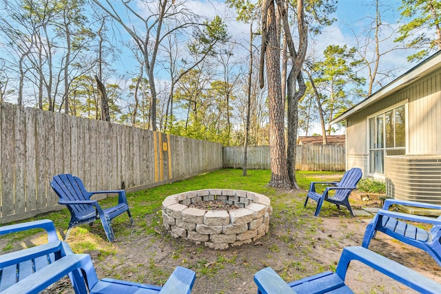 view of yard with a fenced backyard and a fire pit