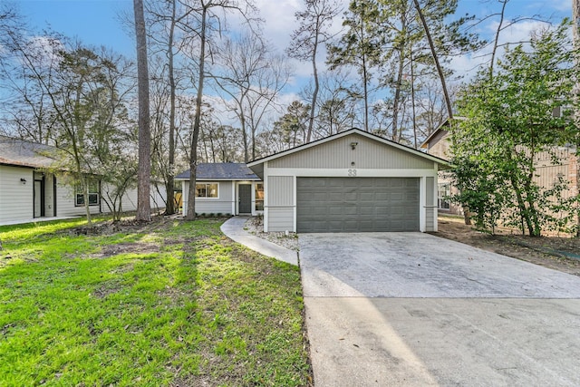 ranch-style home with an outbuilding, driveway, a front lawn, and a garage