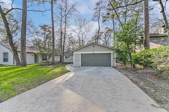 view of front of property featuring a garage, concrete driveway, and a front yard