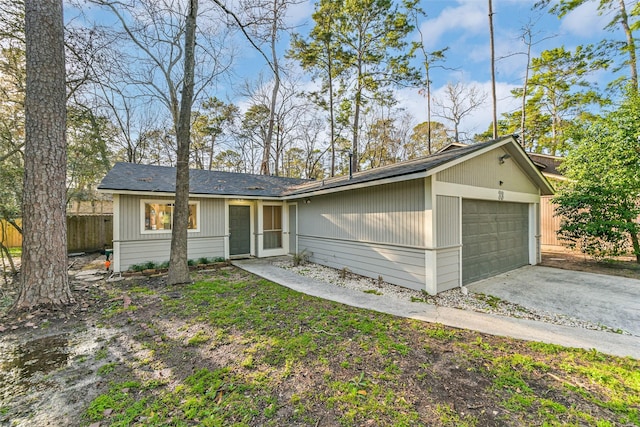 view of front of house featuring fence and an attached garage