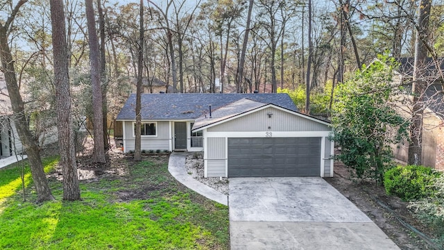 ranch-style home with concrete driveway, roof with shingles, and an attached garage