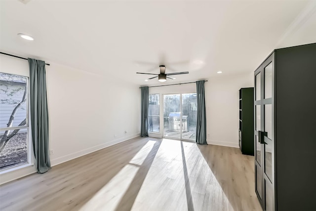 empty room featuring ceiling fan, recessed lighting, light wood-style flooring, and baseboards