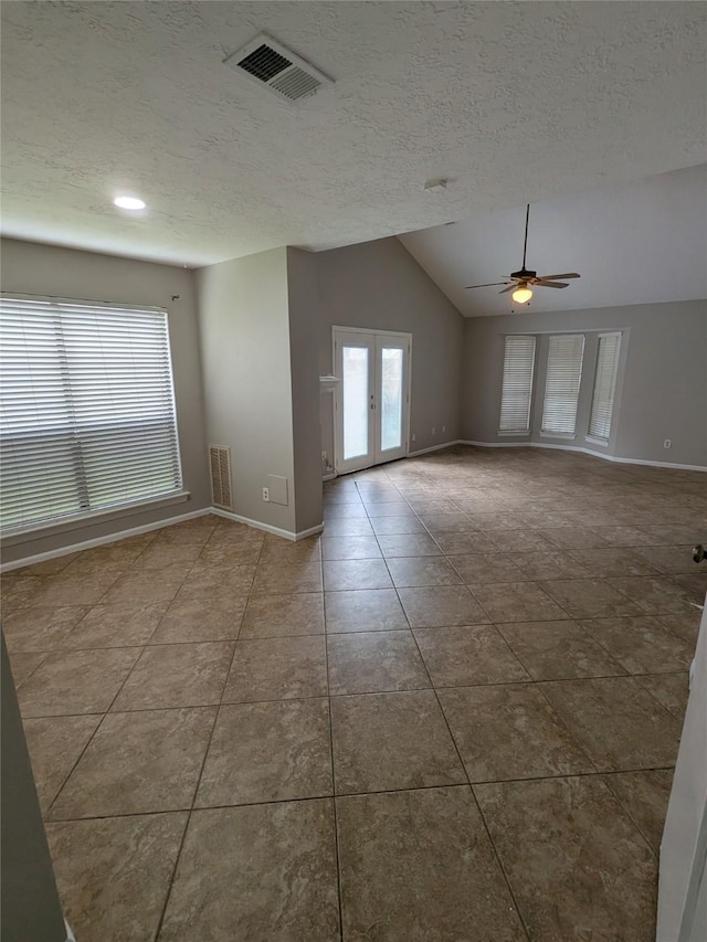 unfurnished room featuring a wealth of natural light, french doors, and visible vents