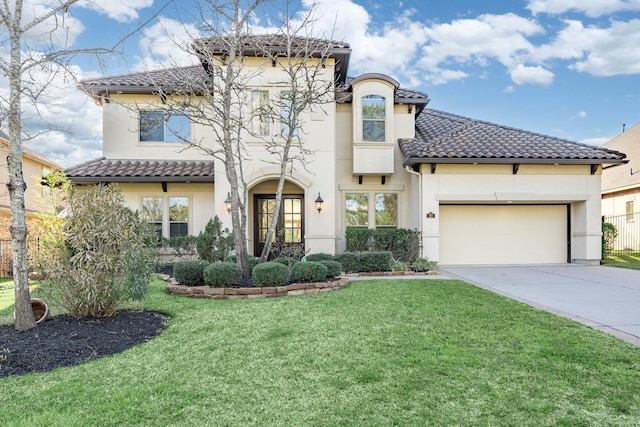 mediterranean / spanish-style house featuring a garage, a tiled roof, a front lawn, and stucco siding