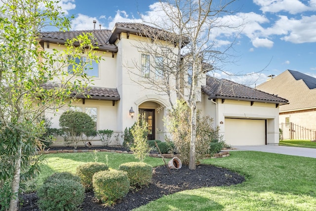 mediterranean / spanish home featuring a tile roof, stucco siding, a garage, driveway, and a front lawn