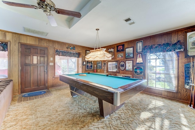 rec room featuring a wealth of natural light, visible vents, and wooden walls