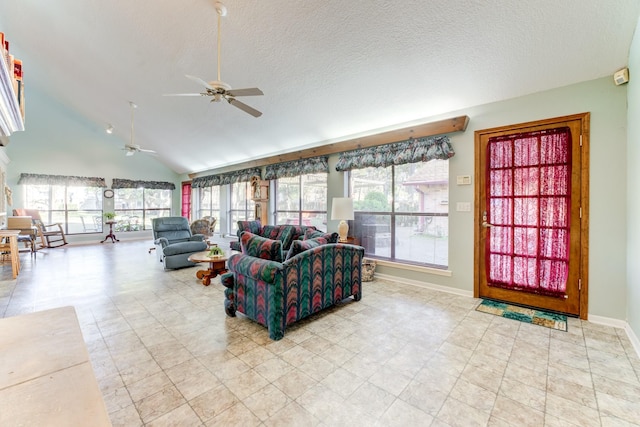 living room featuring lofted ceiling, a ceiling fan, baseboards, and a textured ceiling