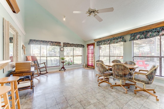 dining area with high vaulted ceiling, a ceiling fan, and a wealth of natural light