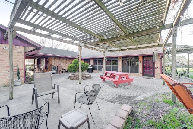 view of patio / terrace featuring an outdoor fire pit and a pergola