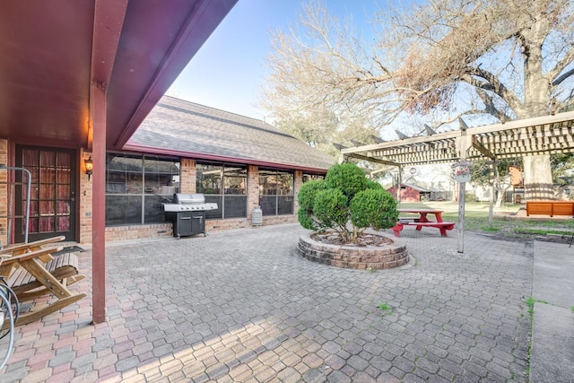 view of patio with a grill and a pergola