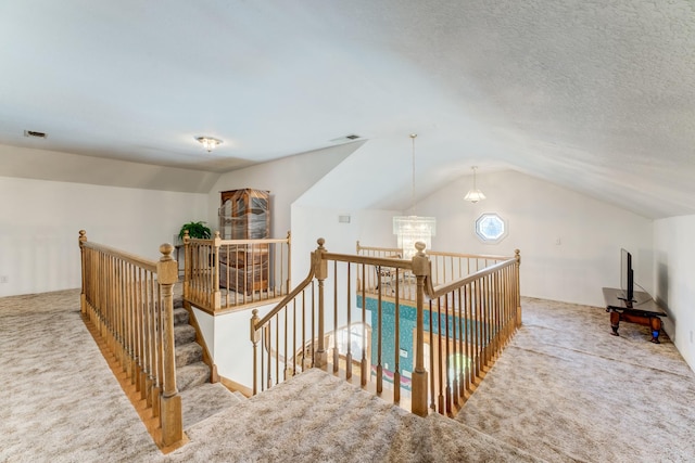 interior space with lofted ceiling, carpet floors, and visible vents