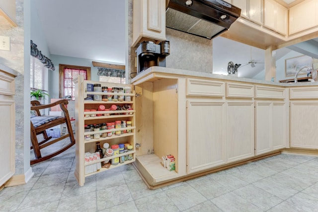 interior space featuring vaulted ceiling, light countertops, extractor fan, and a sink