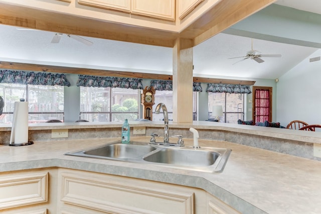 kitchen featuring ceiling fan, visible vents, light countertops, and a sink