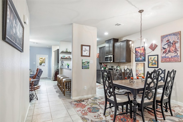 dining space featuring light tile patterned floors, baseboards, visible vents, a chandelier, and recessed lighting