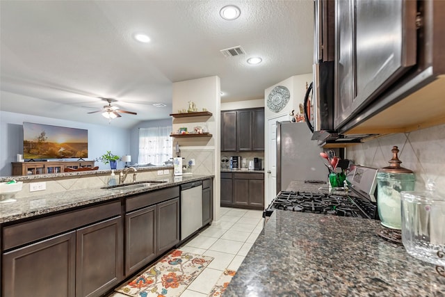 kitchen featuring open shelves, stainless steel appliances, visible vents, a sink, and dark brown cabinetry